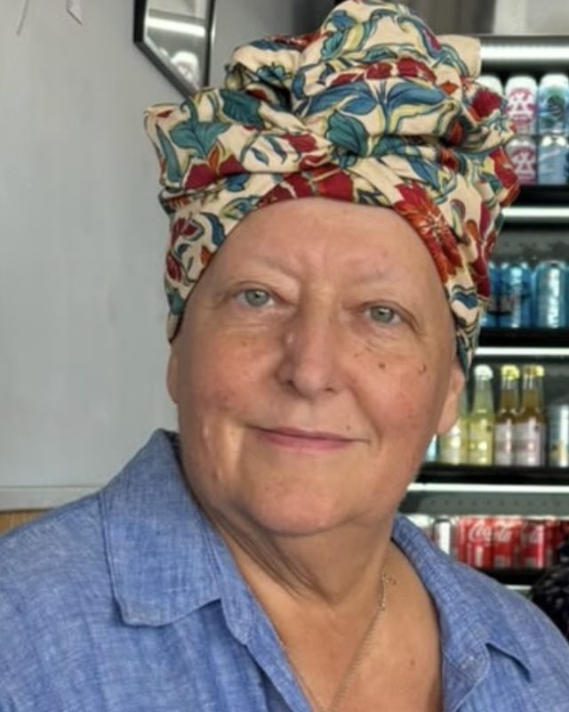Nicola Cairncross, smiling, in a floral turban